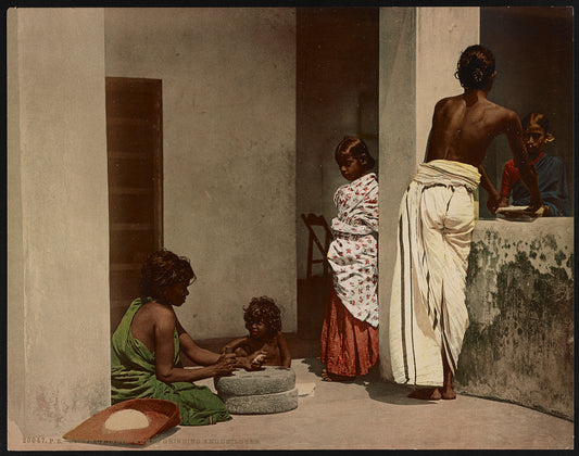 A picture of South of India. Women Grinding and Children